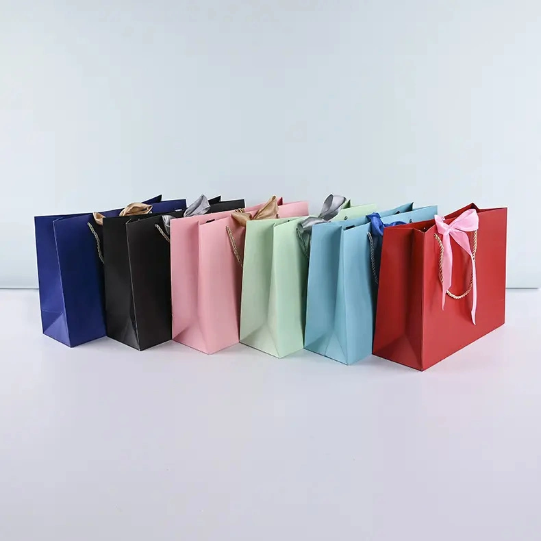 Customised Wholesale Printed Logo Luxury Jewelry Clothing Gift Packing Paper Shopping Bags with Ribbon Bow Twisted Handles